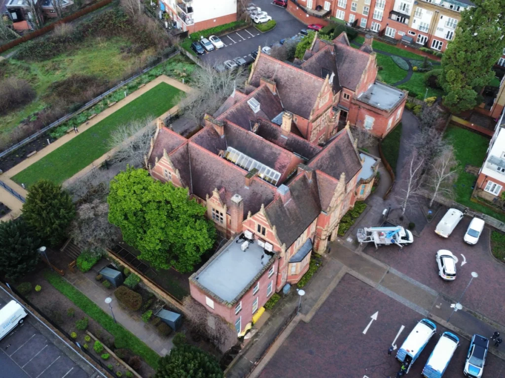 Aerial drone view of the school roof and grounds in Maidstone during the roof cleaning and treatment project
